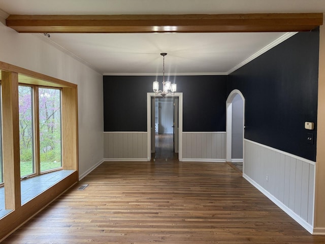 236 N Carolina Ave, Sewanee, TN 37375 - unfurnished dining area with healthy amount of natural light, a chandelier, wainscoting, arched walkways, and wood finished floors