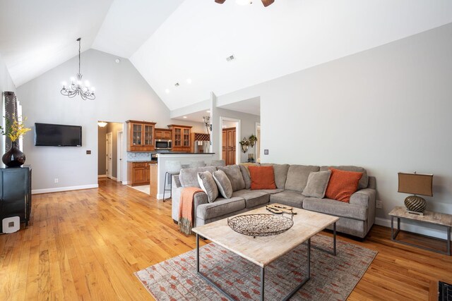 6853 Manassas Gap Ln, Hixson, TN 37343 - living room featuring a chandelier, high vaulted ceiling, and light wood-style floors