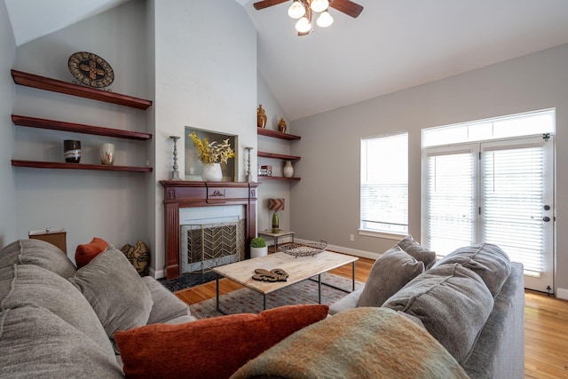6853 Manassas Gap Ln, Hixson, TN 37343 - living area with a ceiling fan, a tile fireplace, wood finished floors, and high vaulted ceiling