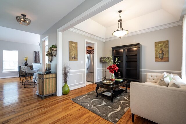 6853 Manassas Gap Ln, Hixson, TN 37343 - living area with wood finished floors, a tray ceiling, a wainscoted wall, and ornamental molding