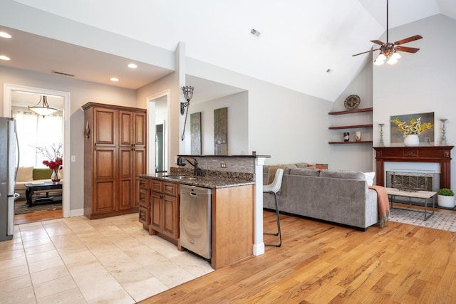 6853 Manassas Gap Ln, Hixson, TN 37343 - kitchen with appliances with stainless steel finishes, a kitchen breakfast bar, open floor plan, dark stone counters, and recessed lighting