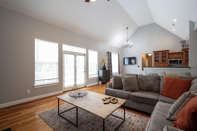 6853 Manassas Gap Ln, Hixson, TN 37343 - living area featuring a chandelier, high vaulted ceiling, light wood-style flooring, and ceiling fan