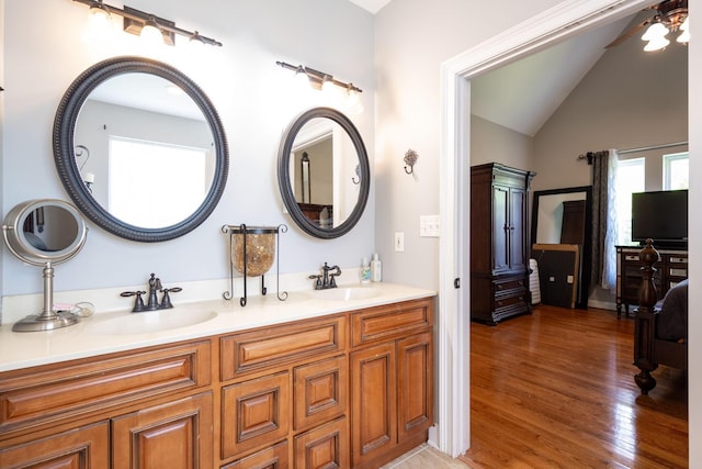 6853 Manassas Gap Ln, Hixson, TN 37343 - bathroom featuring lofted ceiling, double vanity, wood finished floors, and ceiling fan