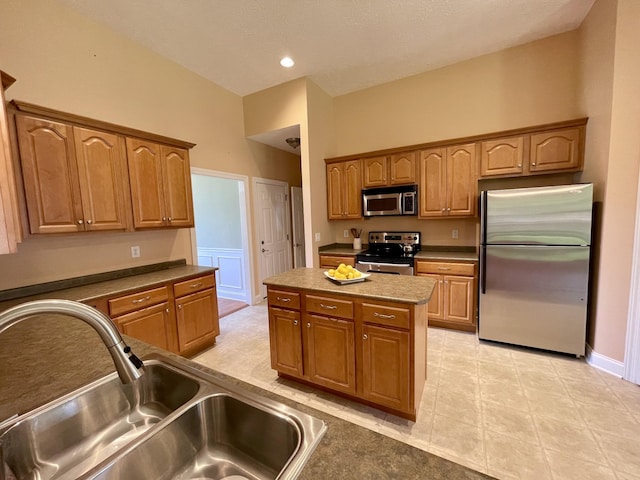 2714 Maylon Dr, Murfreesboro, TN 37128 - kitchen featuring appliances with stainless steel finishes, a kitchen island, and brown cabinets