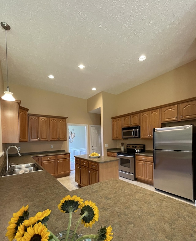 2714 Maylon Dr, Murfreesboro, TN 37128 - kitchen featuring appliances with stainless steel finishes, recessed lighting, dark countertops, brown cabinets, and hanging light fixtures
