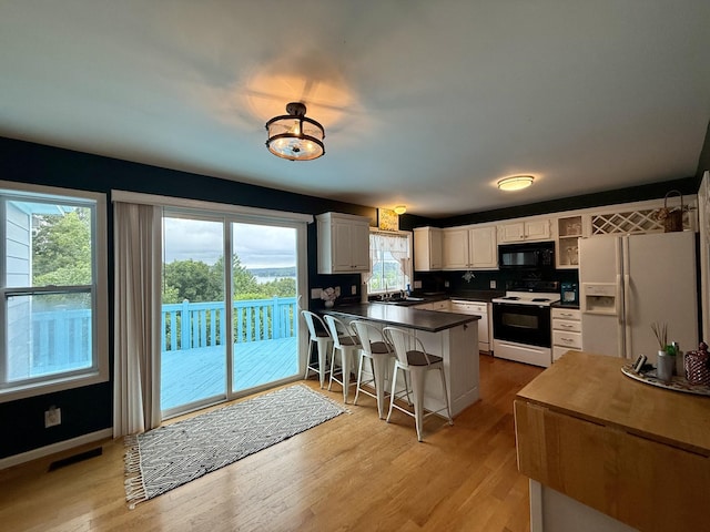 465 Turtle Point Ln, Waverly, TN 37185 - kitchen with white appliances, a peninsula, white cabinetry, and plenty of natural light