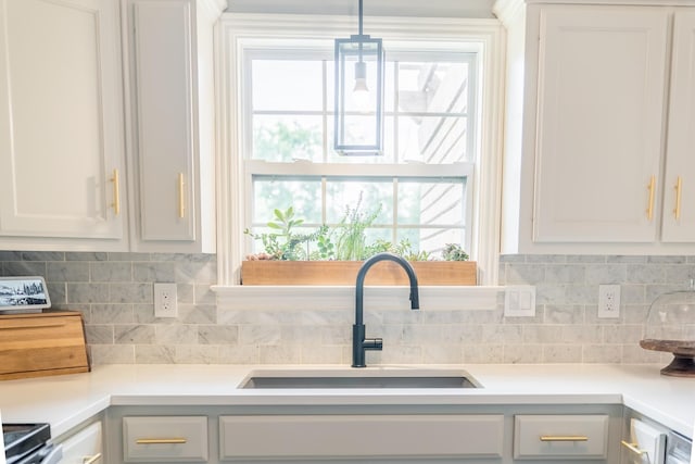 108 Larry Joe Pl, Portland, TN 37148 - kitchen featuring white cabinets, decorative backsplash, light countertops, and decorative light fixtures