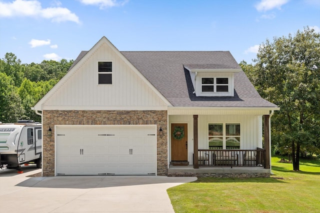 3767 Lee Pike, Soddy Daisy, TN 37379 - view of front facade with covered porch, concrete driveway, stone siding, a front lawn, and roof with shingles