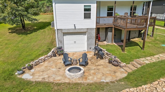 3767 Lee Pike, Soddy Daisy, TN 37379 - rear view of property featuring a fire pit, a lawn, a deck, and a garage