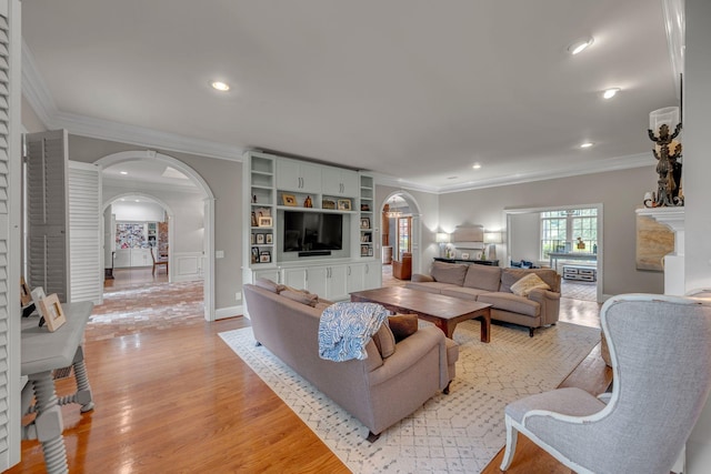 2485 Old Natchez Trce, Franklin, TN 37069 - living room featuring arched walkways, crown molding, light wood-style flooring, and recessed lighting