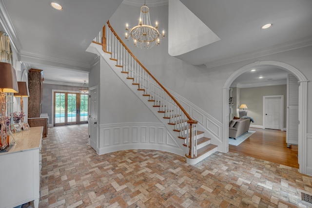 2485 Old Natchez Trce, Franklin, TN 37069 - stairway featuring a chandelier, arched walkways, ornamental molding, brick patterned floors, and recessed lighting