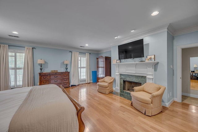 2485 Old Natchez Trce, Franklin, TN 37069 - bedroom featuring multiple windows, wood finished floors, a premium fireplace, ornamental molding, and recessed lighting