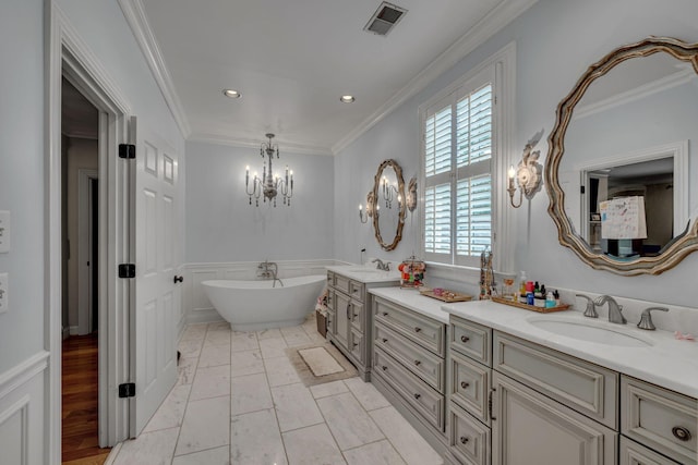 2485 Old Natchez Trce, Franklin, TN 37069 - full bathroom featuring a chandelier, double vanity, a freestanding bath, a wainscoted wall, and recessed lighting