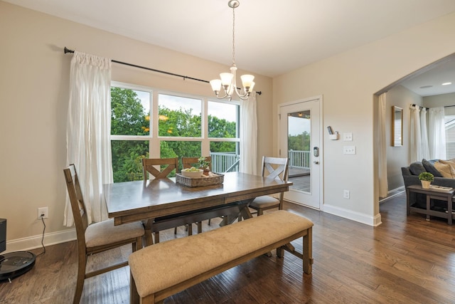 222 Fowler Cir, Franklin, TN 37064 - dining area featuring a chandelier, arched walkways, and dark wood-style flooring