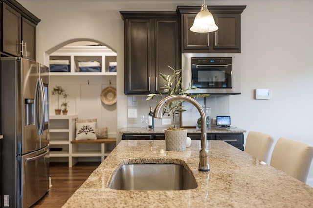 222 Fowler Cir, Franklin, TN 37064 - kitchen featuring stainless steel refrigerator with ice dispenser, dark brown cabinets, arched walkways, and dark wood-style flooring