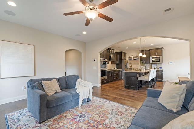 222 Fowler Cir, Franklin, TN 37064 - living room with arched walkways, dark wood-type flooring, ceiling fan, and recessed lighting