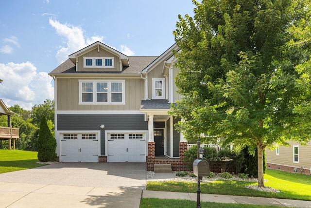 222 Fowler Cir, Franklin, TN 37064 - view of front of house with concrete driveway, board and batten siding, an attached garage, a front yard, and brick siding