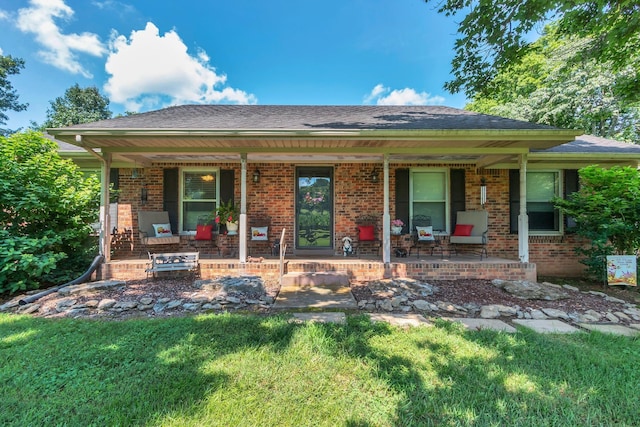 3349 Sweeney Hollow Rd, Franklin, TN 37064 - ranch-style house featuring a porch, brick siding, a front yard, and a shingled roof