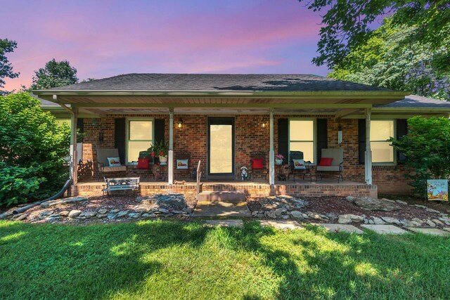 3349 Sweeney Hollow Rd, Franklin, TN 37064 - ranch-style house featuring covered porch, brick siding, a lawn, and a shingled roof