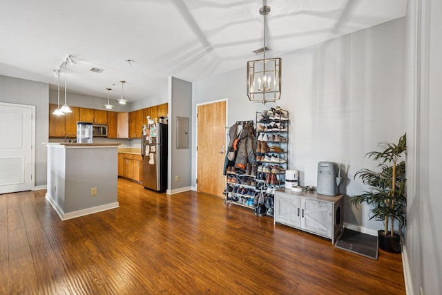863 Flynn St Unit 302, Chattanooga, TN 37403 - kitchen with appliances with stainless steel finishes, brown cabinets, dark wood-style floors, decorative light fixtures, and a chandelier