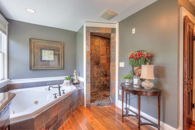 9710 Concord Rd, Brentwood, TN 37027 - full bathroom with a jetted tub, a stall shower, and wood finished floors