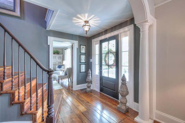 9710 Concord Rd, Brentwood, TN 37027 - entrance foyer featuring hardwood / wood-style floors, stairs, ornate columns, and arched walkways