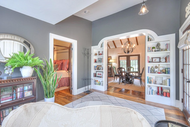 9710 Concord Rd, Brentwood, TN 37027 - bedroom with a chandelier, wood finished floors, and arched walkways