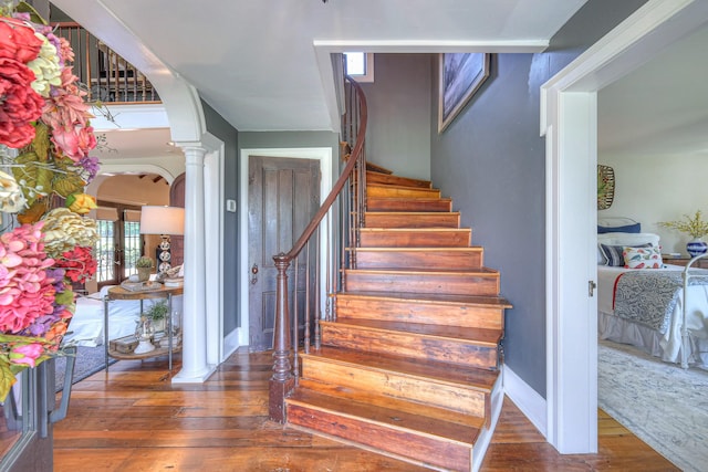 9710 Concord Rd, Brentwood, TN 37027 - staircase with hardwood / wood-style flooring, ornate columns, and arched walkways