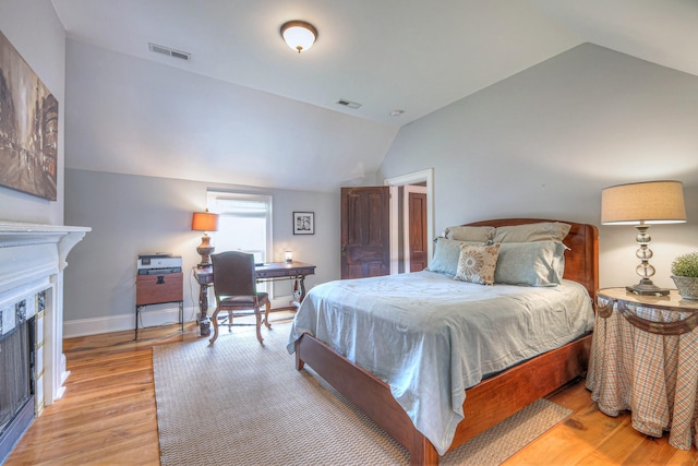 9710 Concord Rd, Brentwood, TN 37027 - bedroom with vaulted ceiling, a fireplace, light wood finished floors, and a desk