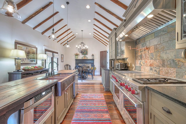 9710 Concord Rd, Brentwood, TN 37027 - kitchen featuring appliances with stainless steel finishes, wall chimney exhaust hood, hanging light fixtures, glass insert cabinets, and recessed lighting