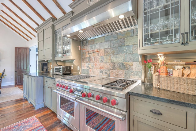 9710 Concord Rd, Brentwood, TN 37027 - kitchen featuring range with two ovens, wall chimney exhaust hood, dark wood finished floors, gray cabinetry, and glass insert cabinets