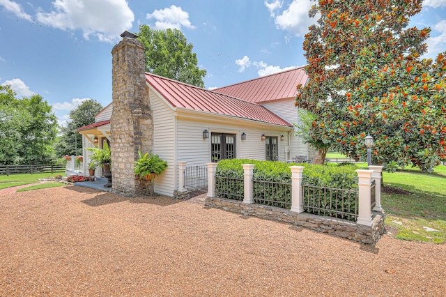 9710 Concord Rd, Brentwood, TN 37027 - view of side of property featuring a chimney, a standing seam roof, and a metal roof