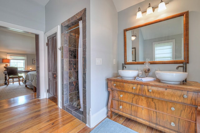9710 Concord Rd, Brentwood, TN 37027 - full bathroom with wood finished floors, double vanity, a tile shower, ensuite bathroom, and lofted ceiling