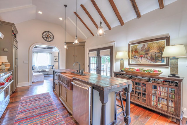 9710 Concord Rd, Brentwood, TN 37027 - kitchen featuring appliances with stainless steel finishes, butcher block countertops, healthy amount of natural light, a kitchen island with sink, and recessed lighting