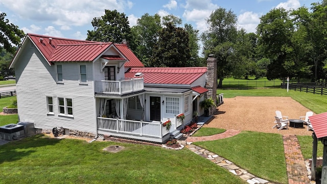 9710 Concord Rd, Brentwood, TN 37027 - rear view of house with a standing seam roof, a balcony, a chimney, and a metal roof