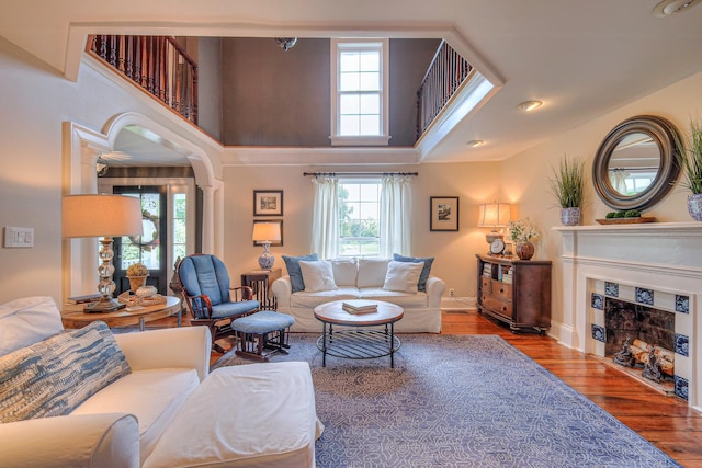 9710 Concord Rd, Brentwood, TN 37027 - living area with healthy amount of natural light, a fireplace with flush hearth, wood finished floors, and a high ceiling