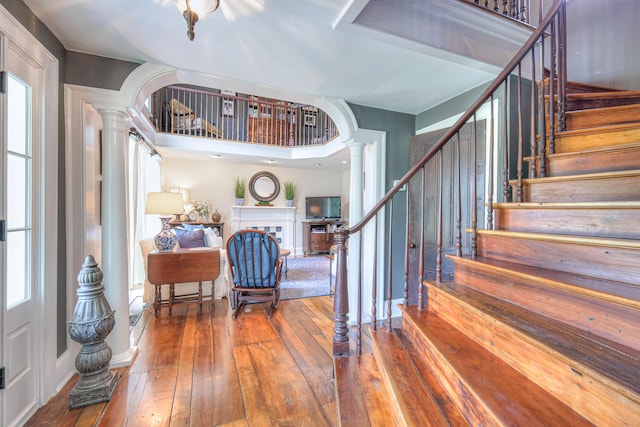 9710 Concord Rd, Brentwood, TN 37027 - entryway featuring ornate columns, wood-type flooring, and stairs