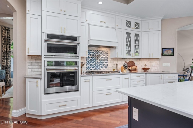 145 Pineridge Loop, Crossville, TN 38558 - kitchen with arched walkways, dark wood-type flooring, white cabinets, appliances with stainless steel finishes, and recessed lighting