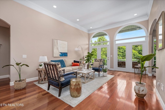 145 Pineridge Loop, Crossville, TN 38558 - living room with arched walkways, wood-type flooring, ornamental molding, recessed lighting, and french doors