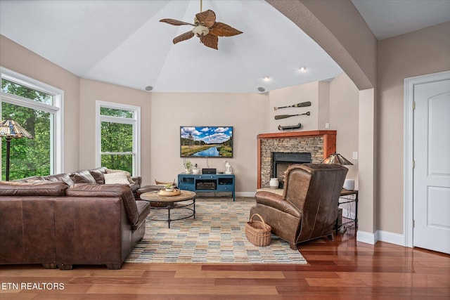 145 Pineridge Loop, Crossville, TN 38558 - living room featuring wood finished floors, ceiling fan, vaulted ceiling, and a fireplace