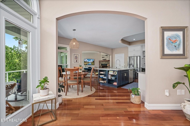 145 Pineridge Loop, Crossville, TN 38558 - dining area featuring arched walkways and wood finished floors