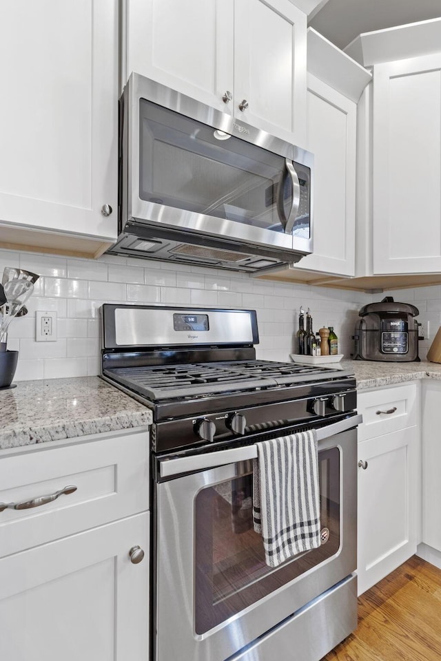 4252 Inlet Loop, Chattanooga, TN 37416 - kitchen featuring stainless steel appliances, tasteful backsplash, and white cabinets