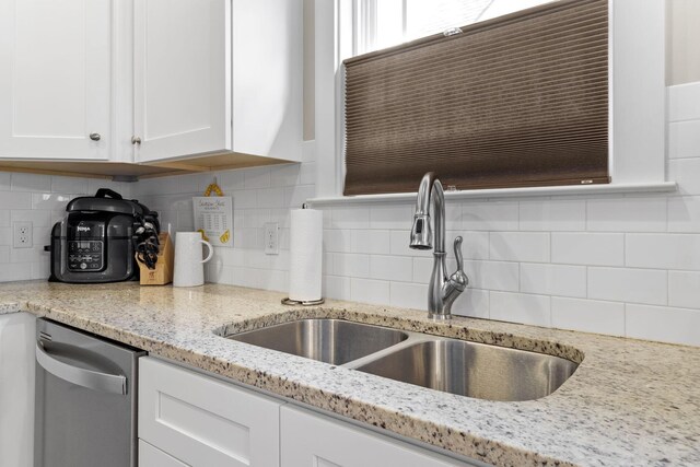 4252 Inlet Loop, Chattanooga, TN 37416 - kitchen with stainless steel dishwasher, white cabinetry, backsplash, and light stone countertops