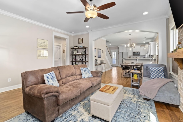 4252 Inlet Loop, Chattanooga, TN 37416 - living room with arched walkways, ceiling fan, stairs, wood finished floors, and crown molding