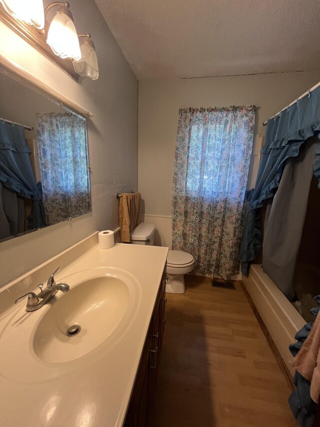 1465 Old Farmington Rd, Lewisburg, TN 37091 - full bathroom with vanity, a textured ceiling, wood finished floors, and shower / tub combo