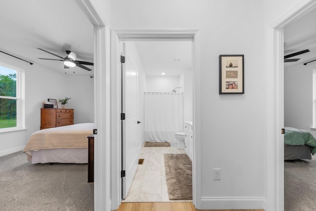 5283 Eagleville Pike, Eagleville, TN 37060 - bedroom featuring connected bathroom, light marble finish floors, and a ceiling fan