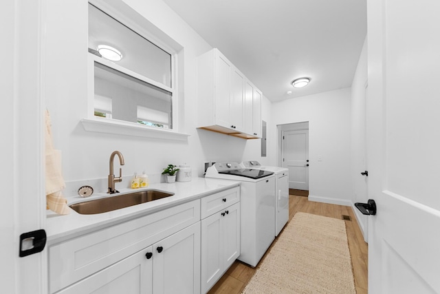 5283 Eagleville Pike, Eagleville, TN 37060 - kitchen featuring washer and clothes dryer, white cabinetry, light wood finished floors, and light countertops