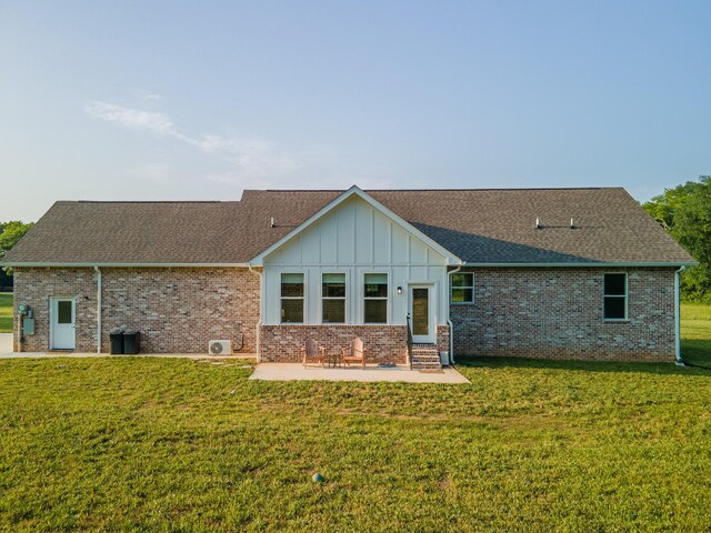 5283 Eagleville Pike, Eagleville, TN 37060 - back of property with a patio area, a yard, a shingled roof, board and batten siding, and brick siding