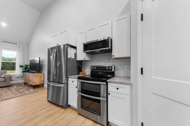 5283 Eagleville Pike, Eagleville, TN 37060 - kitchen with appliances with stainless steel finishes, tasteful backsplash, light wood finished floors, white cabinets, and light stone countertops