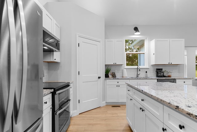 5283 Eagleville Pike, Eagleville, TN 37060 - kitchen with stainless steel appliances, light wood-style floors, backsplash, and white cabinets